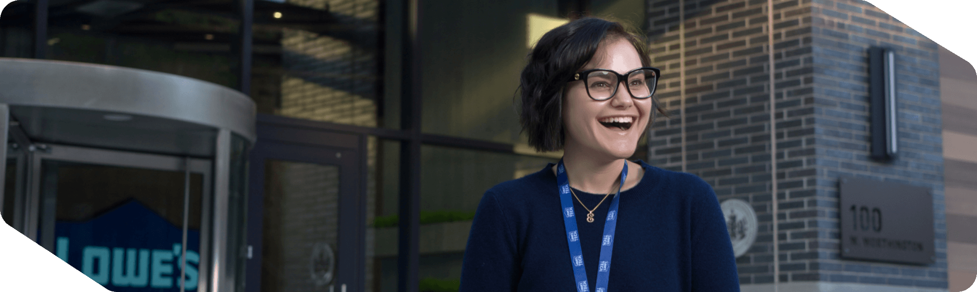 Female associate standing outside of the Tech Hub