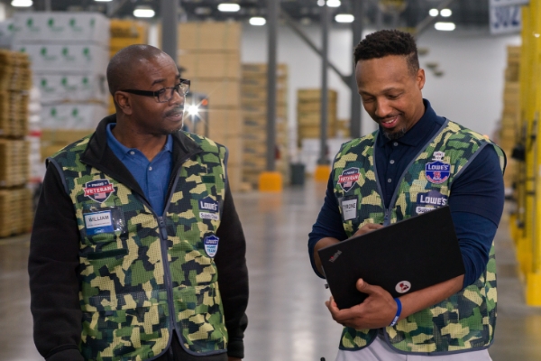 Supply Chain team members wearing Lowe's military vests