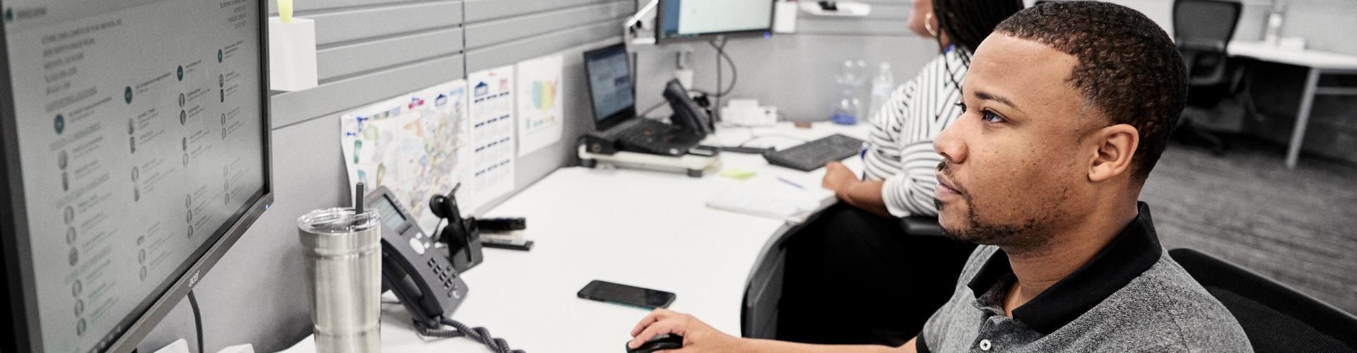Male associate working in his cubicle