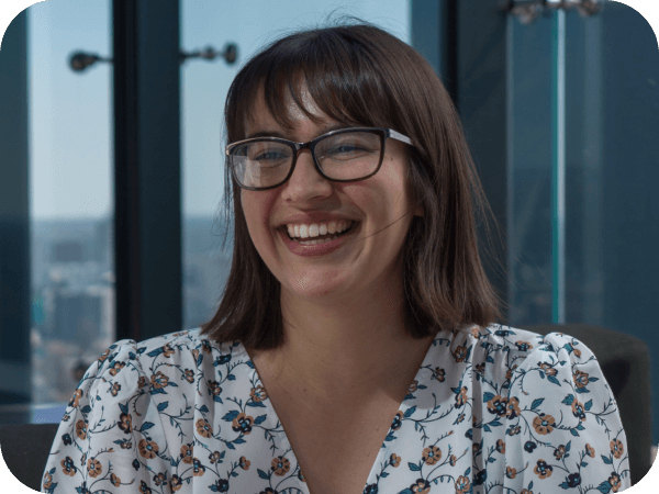Lowe’s associate with glasses smiling in an office setting.
