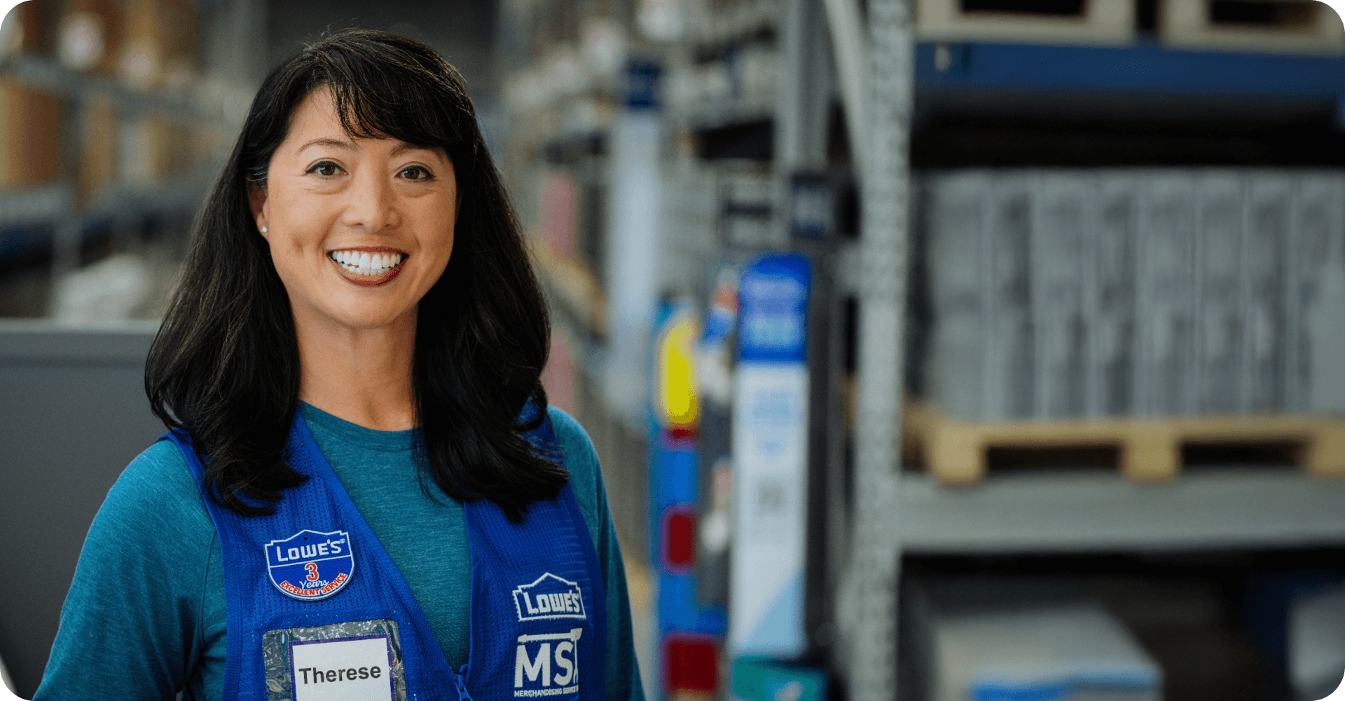 Lowe's MST associate smiling while working in an aisle