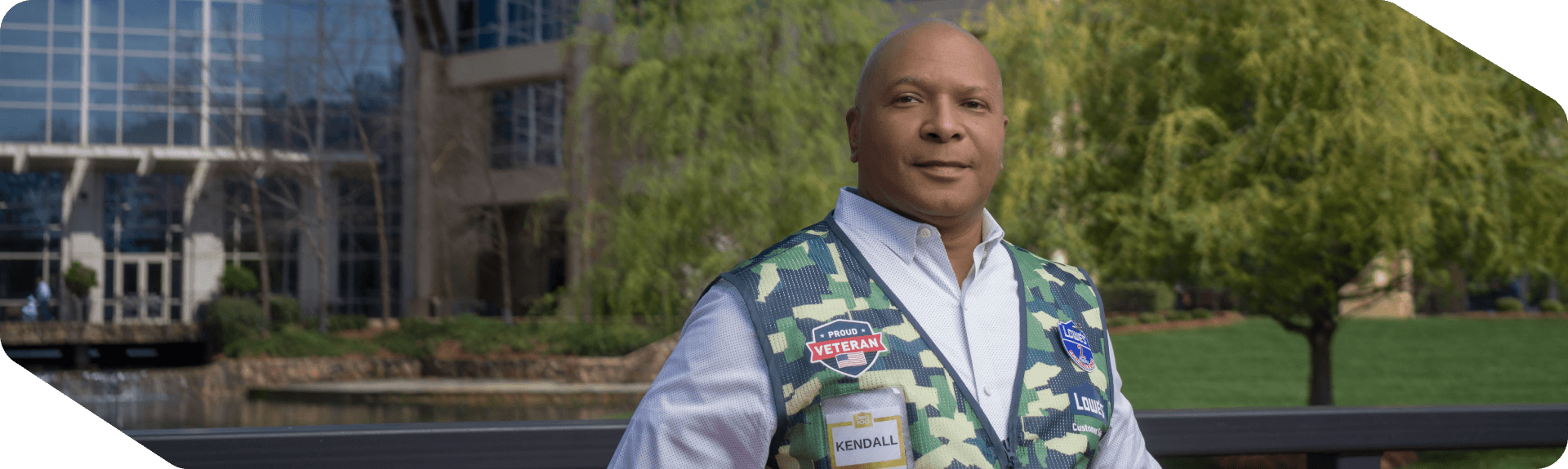 Lowe's associate and Military Veteran standing confidently outside of corporate headquarters