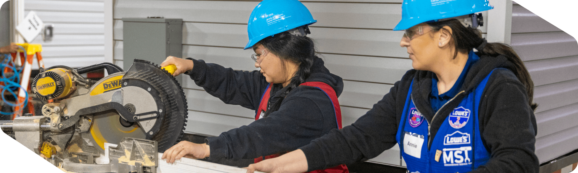 Two store associates volunteering for Habitat for Humanity