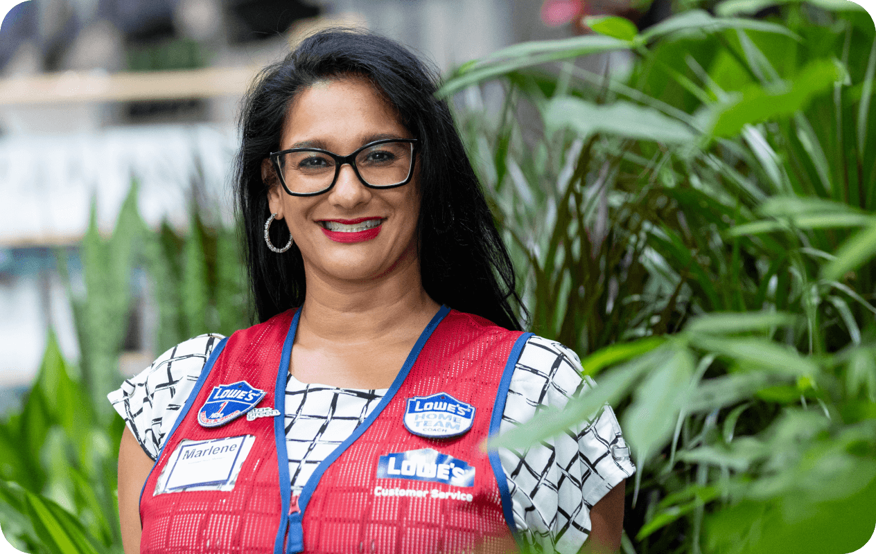 Lowe's associate wearing a red vest working in the Garden Center