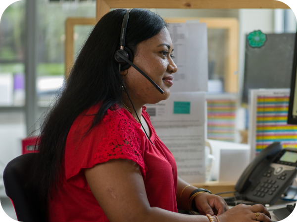 Lowe's associate taking a customer's call at her desk