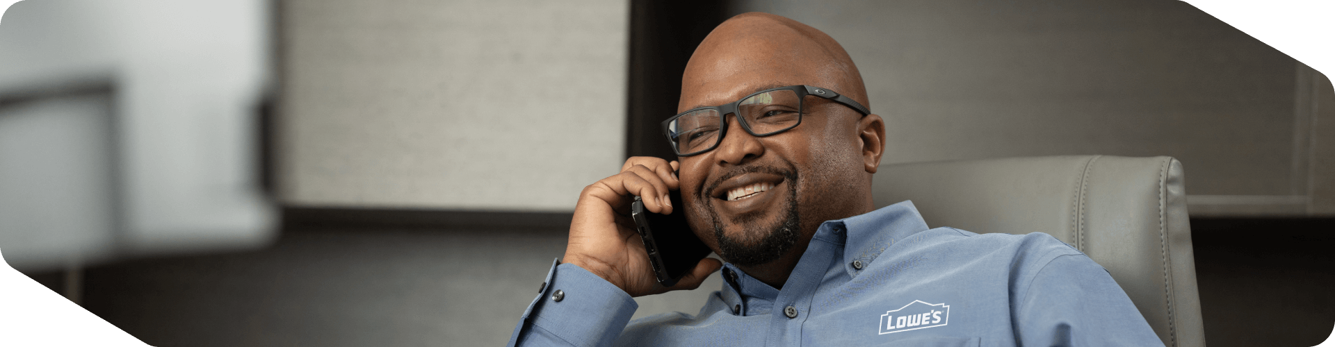 Lowe's associate speaking on his phone in his office