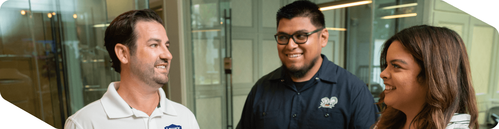 Lowe's sales associate assisting two customers at their office