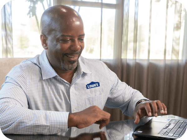 Lowe's sales associate working on his computer