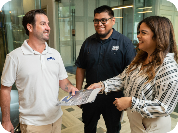 Lowe's sales associate assisting two customers at their office