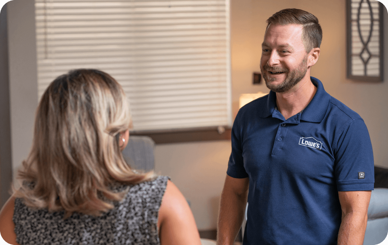 Lowe's associate speaking to a customer in her office