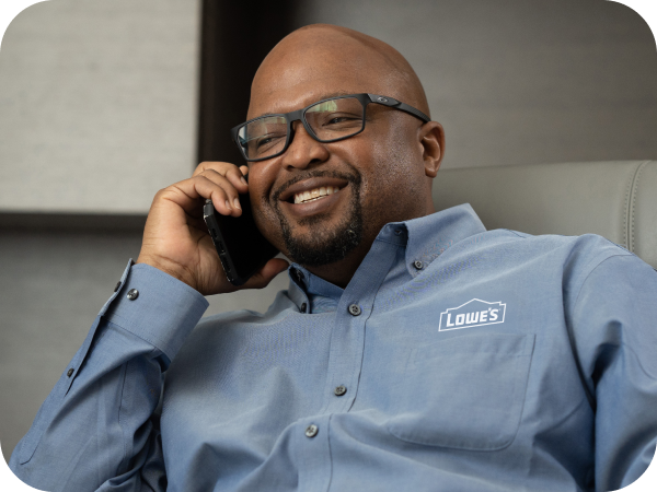 Lowe's associate speaking on his phone in his office