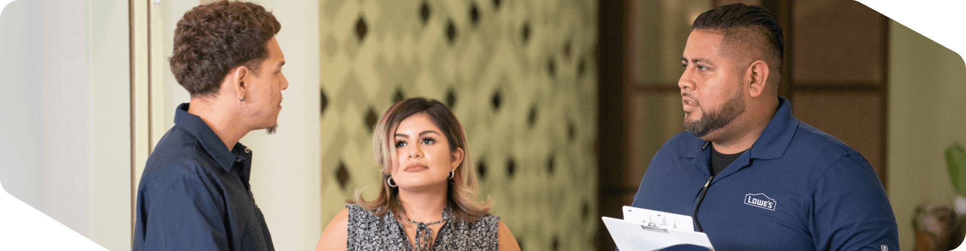 Lowe's associate assisting two customers with a sale