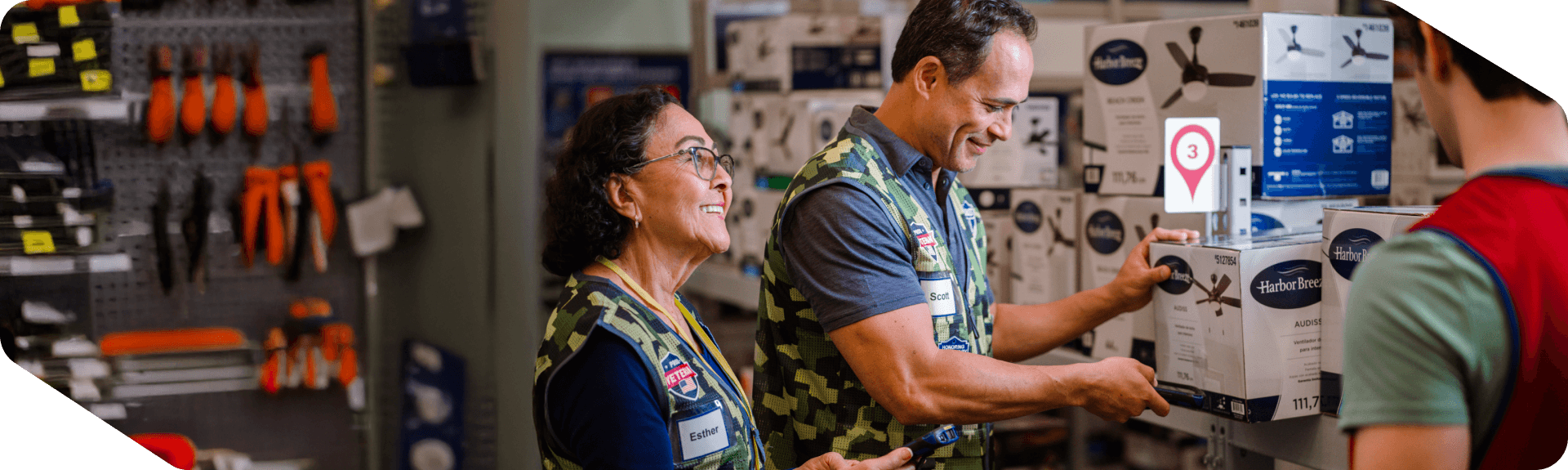 Lowe's associates wearing military vests stocking shelves in the store