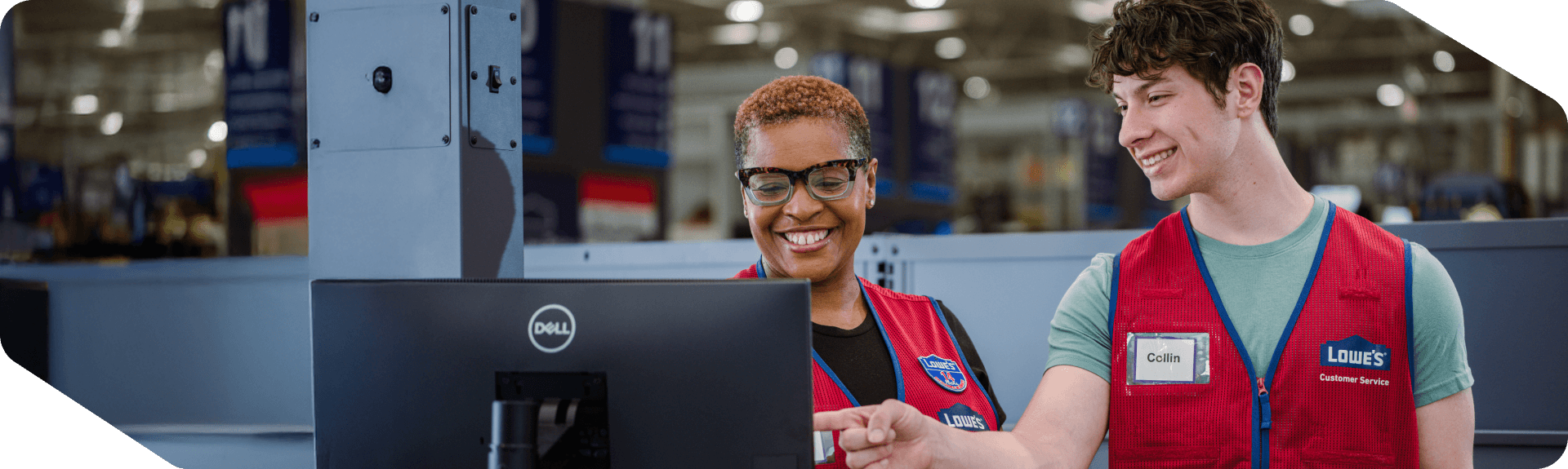 Lowe's store associates working together at the customer service desk