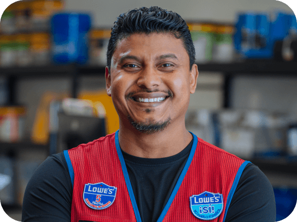 Lowe's associate smiling while working as a Stocker/Receiver