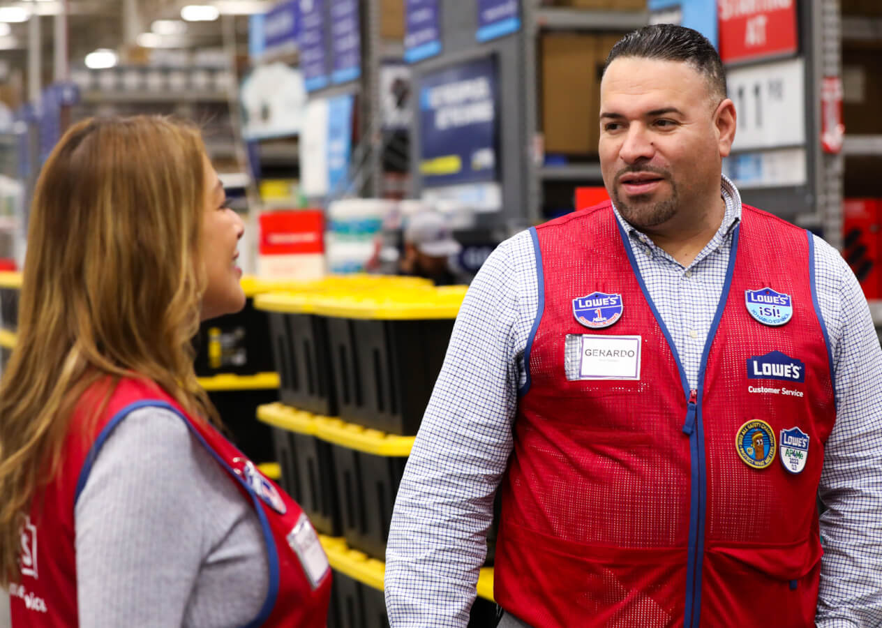 Bilingual store manager talking with an associate