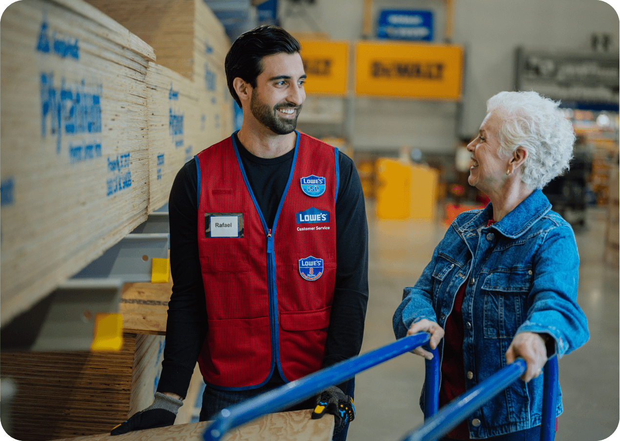 Lowe's associate helping a customer with lumber