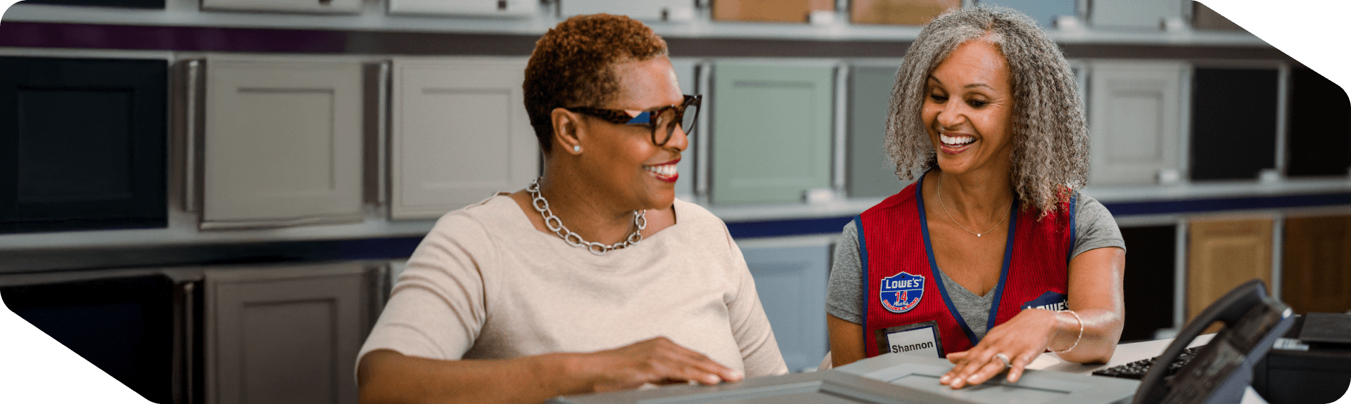 Lowe's Sales Specialist helping a customer with a cabinet order