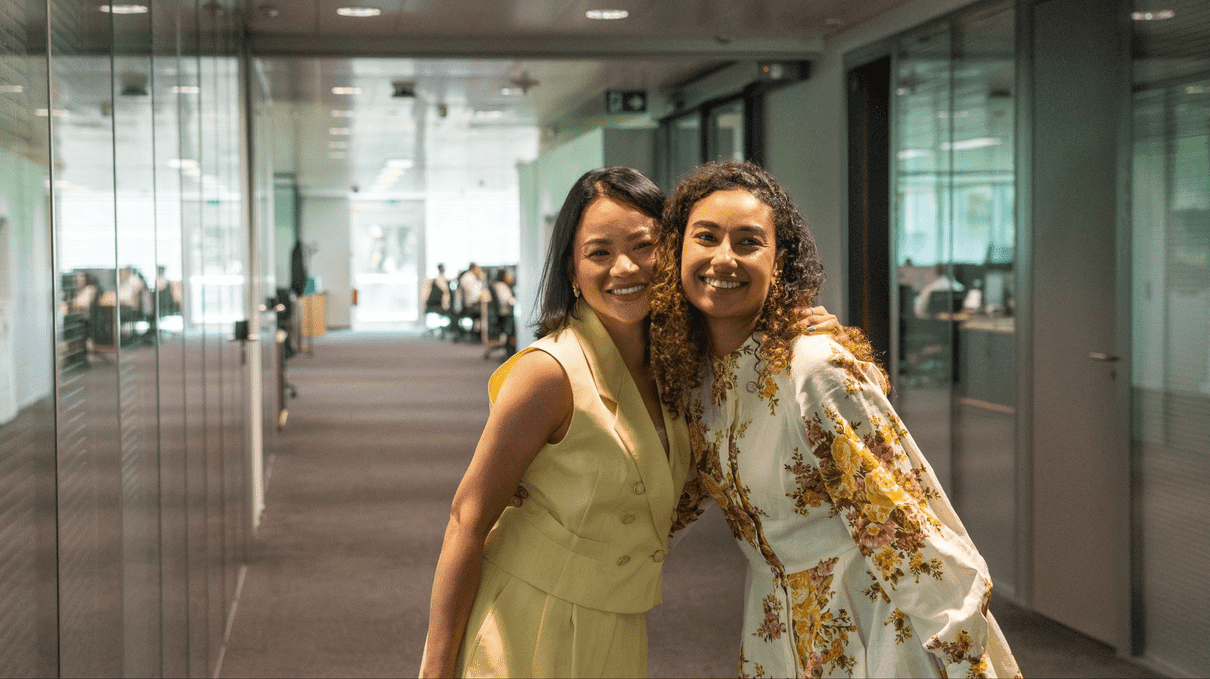Two MSC Cruises colleagues in the Geneva office smiling.