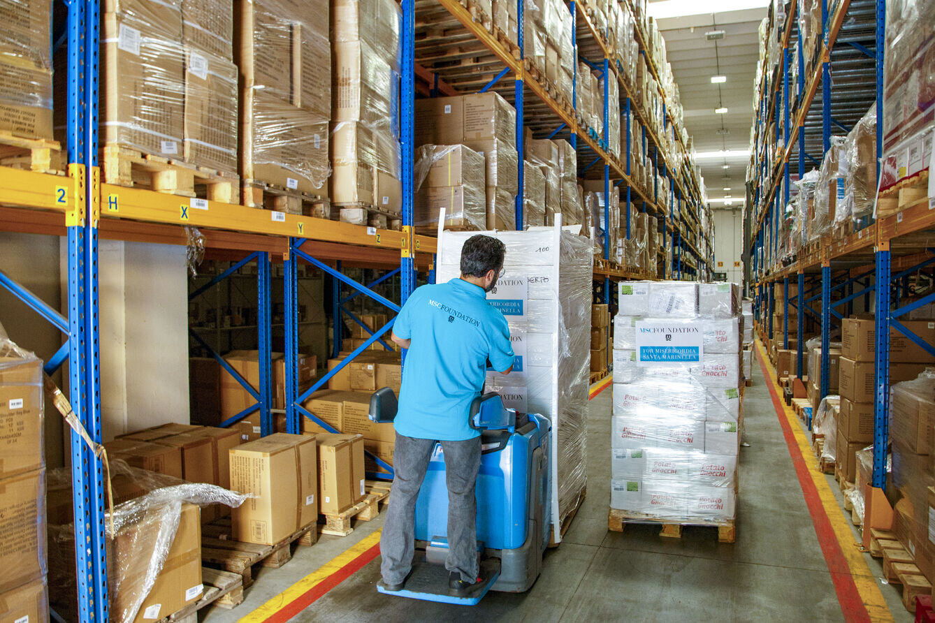 MSC Foundation team member working in a storage room, representing humanitarian operations