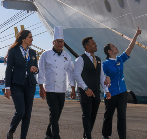 MSC Cruises crew members smiling outside the ship, representing life at sea and career opportunities on board