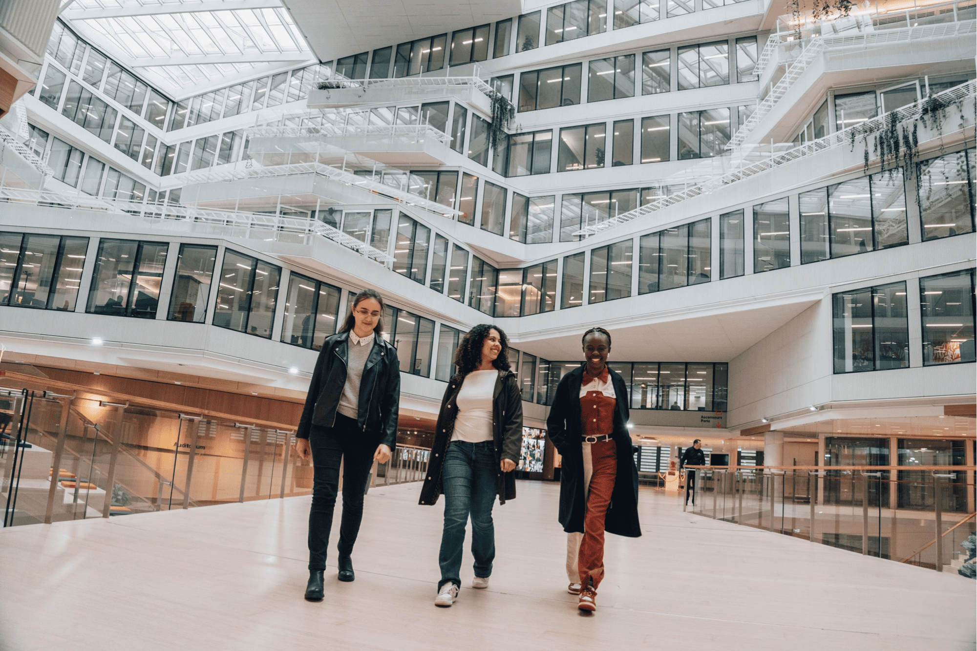 The stunning multi-level atrium of our headquarters, showcasing contemporary architecture and interconnected social spaces for employees.