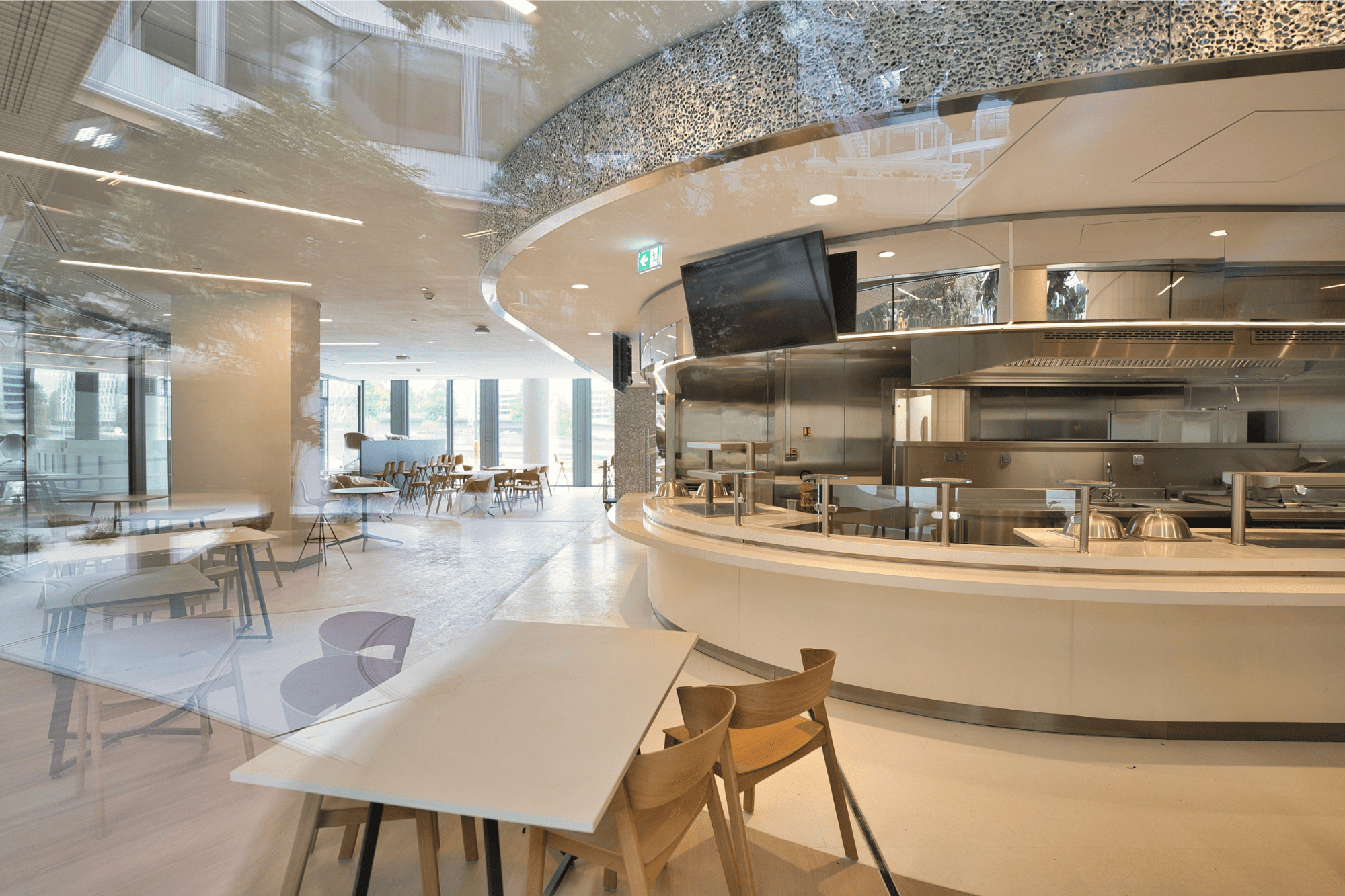 A clean, contemporary on-site dining facility providing employees with a high-quality space to recharge and socialize during lunch hours.