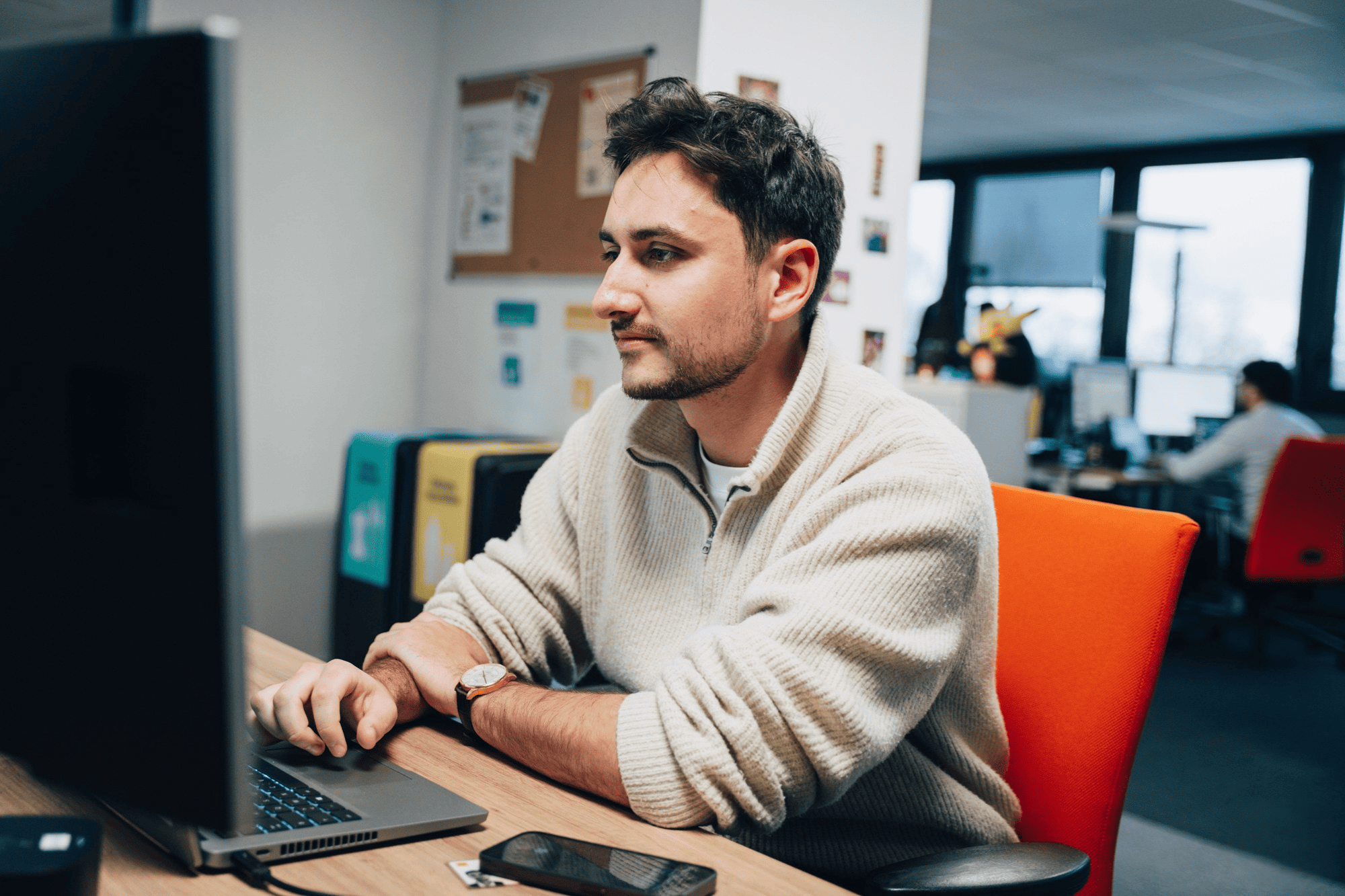 A professional at a dedicated workstation in our Nantes office, highlighting the quiet, focused environments available to our teams.