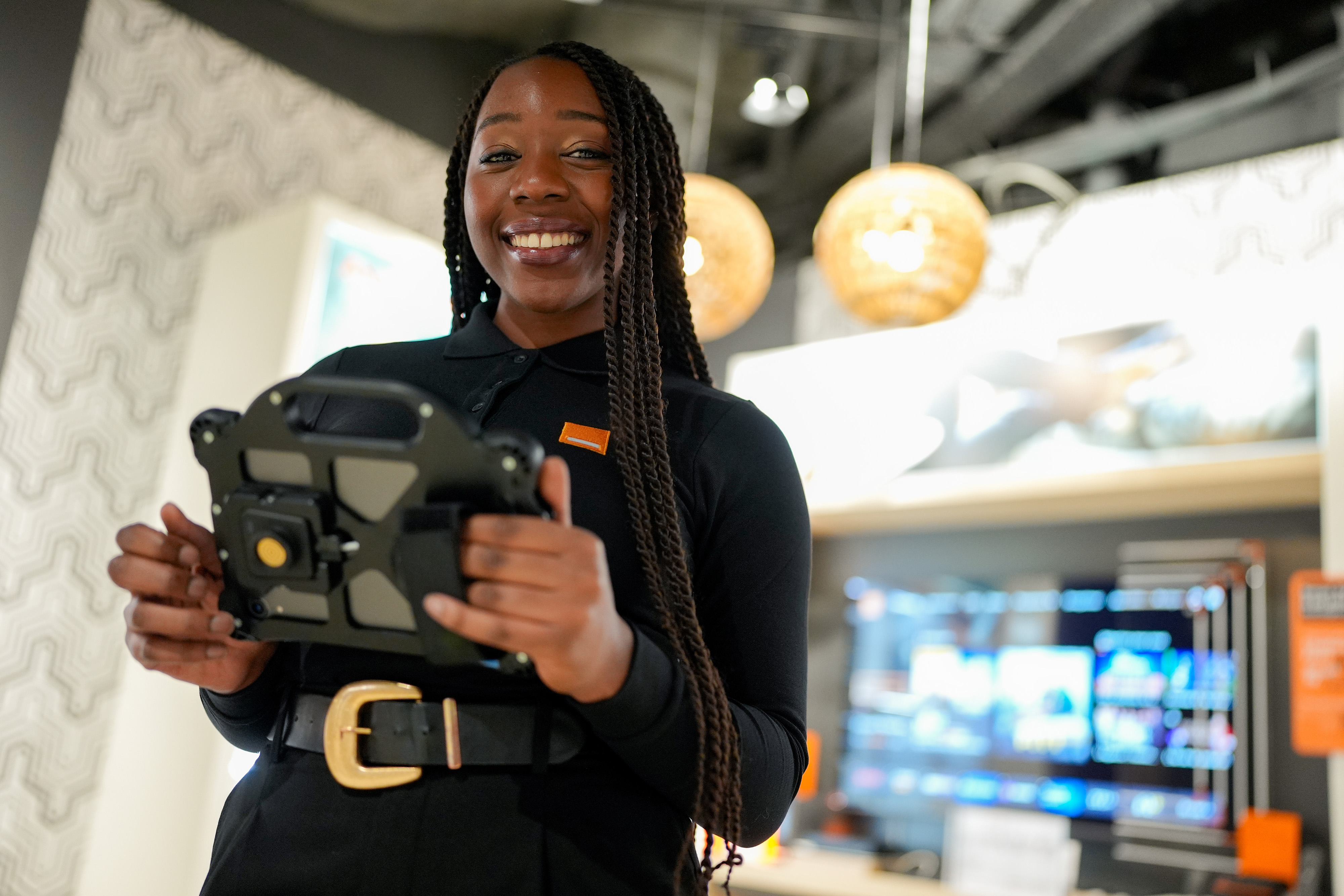 Smiling Orange advisor holding a tablet