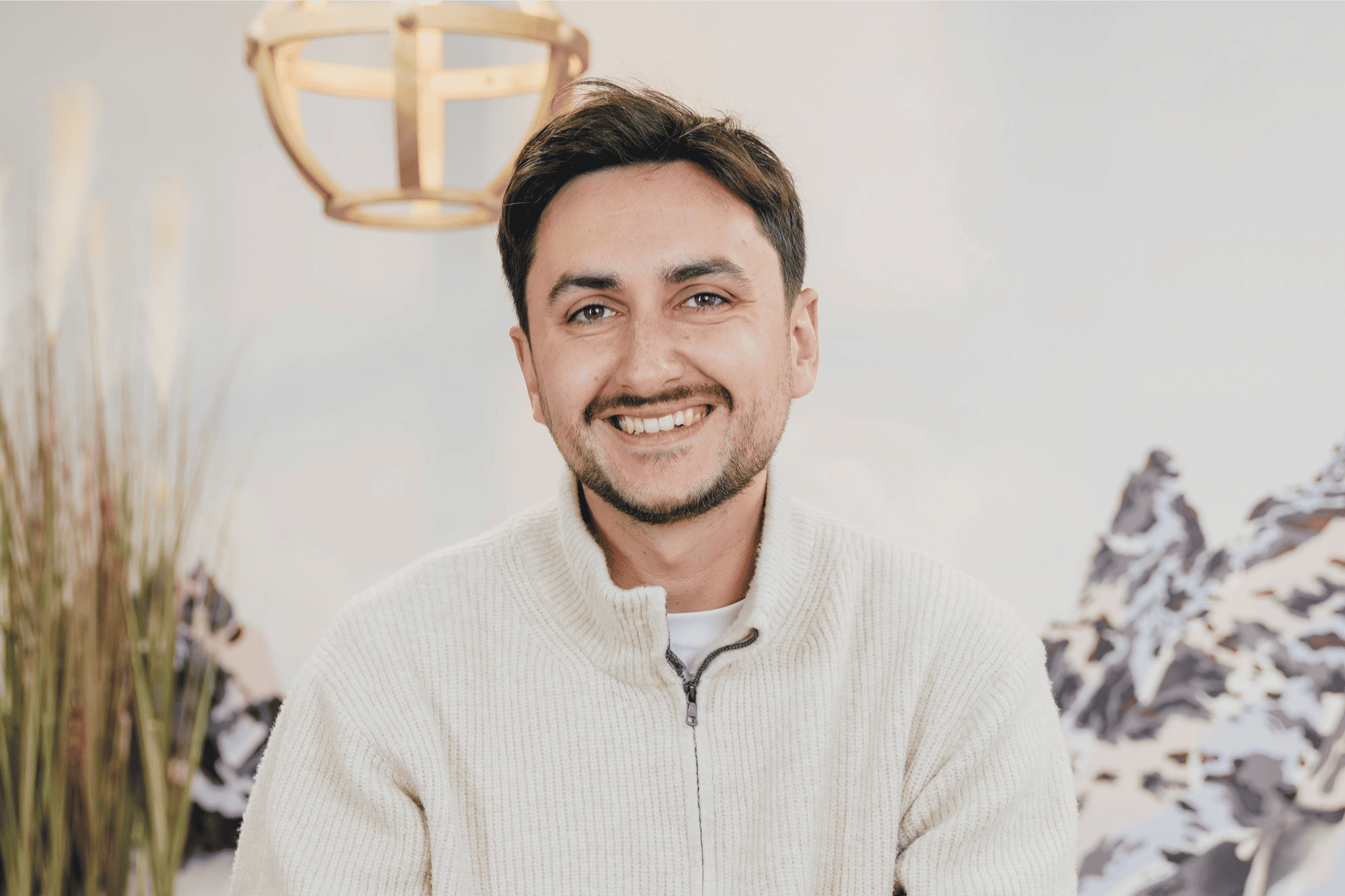 Portrait of Antoine, an AI Consultant at Orange Business, smiling in a creative office environment with modern lighting.