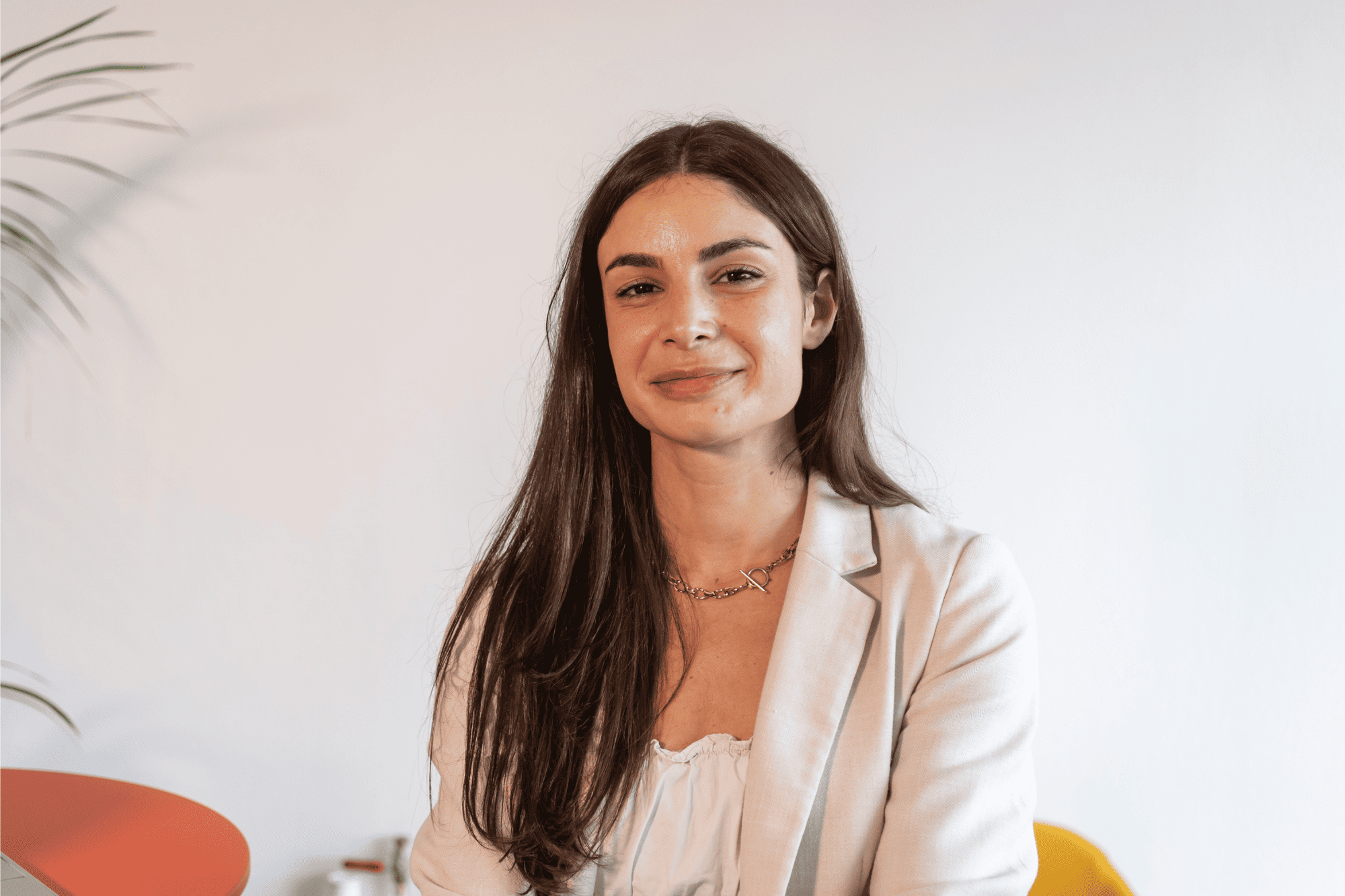 Professional portrait of Mireia, a collaborator at Orange Business, smiling in a modern and light office.