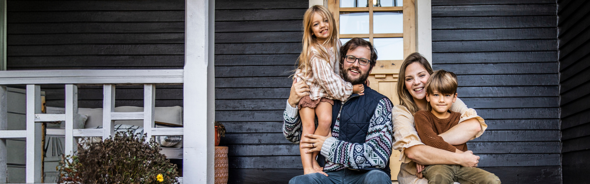 A family sitting on porch steps
