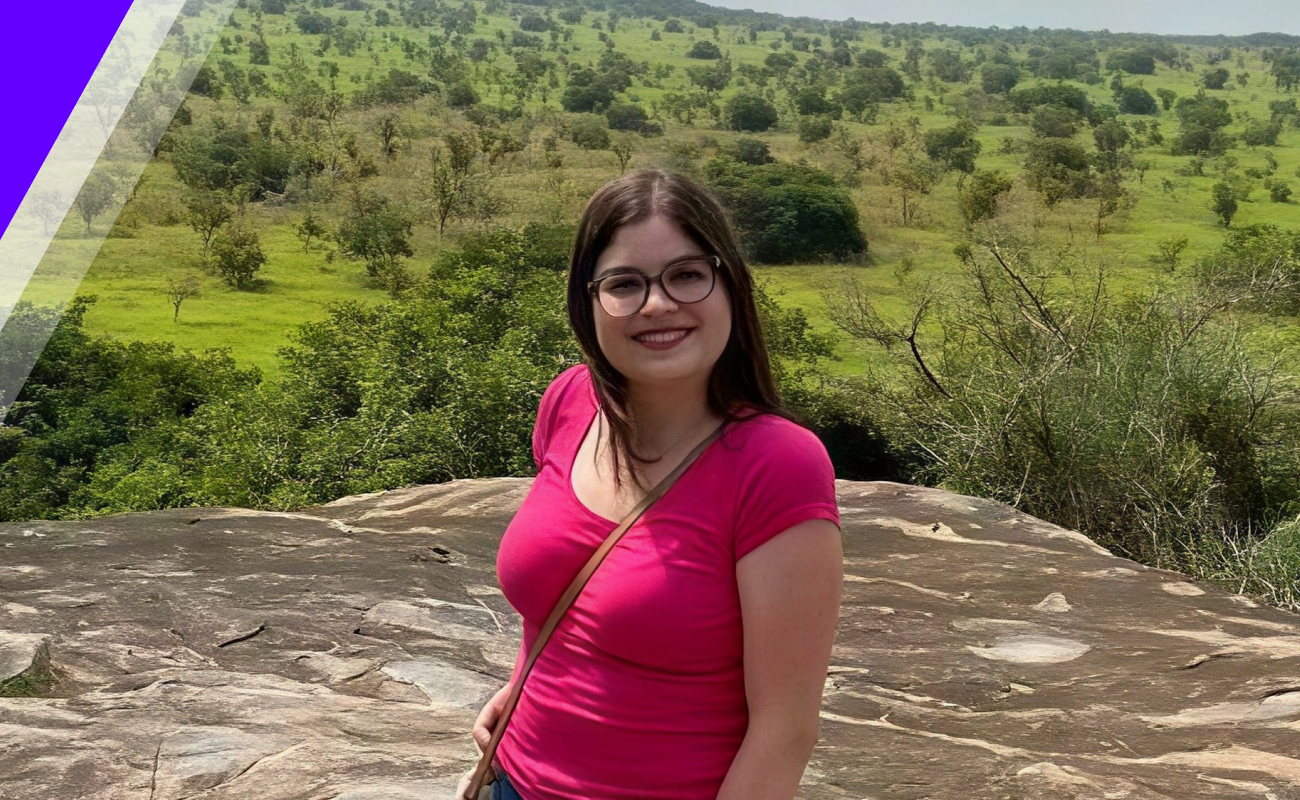 Leah standing on top of rock with view behind her